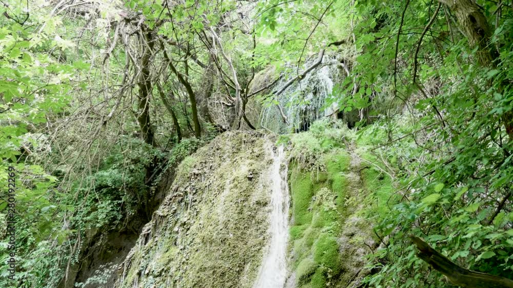 Slow motion shot of beautiful waterfall in the nature on the mountains Slow motion shot of beautiful waterfall in the nature on the mountains