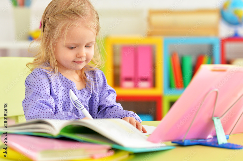 Cute teen girl doing homework in her room Cute teen girl doing homework in her room