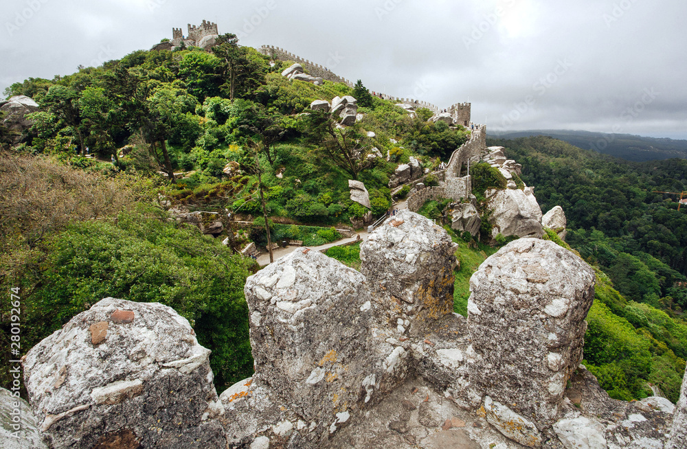 Stone defensive towers of the 8th century The Moorish Castle Castle over town Sintra. Historical landscape in Portugal