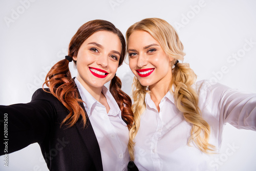 Photo of two classmates ladies making selfies while coffee break wear costumes isolated white background