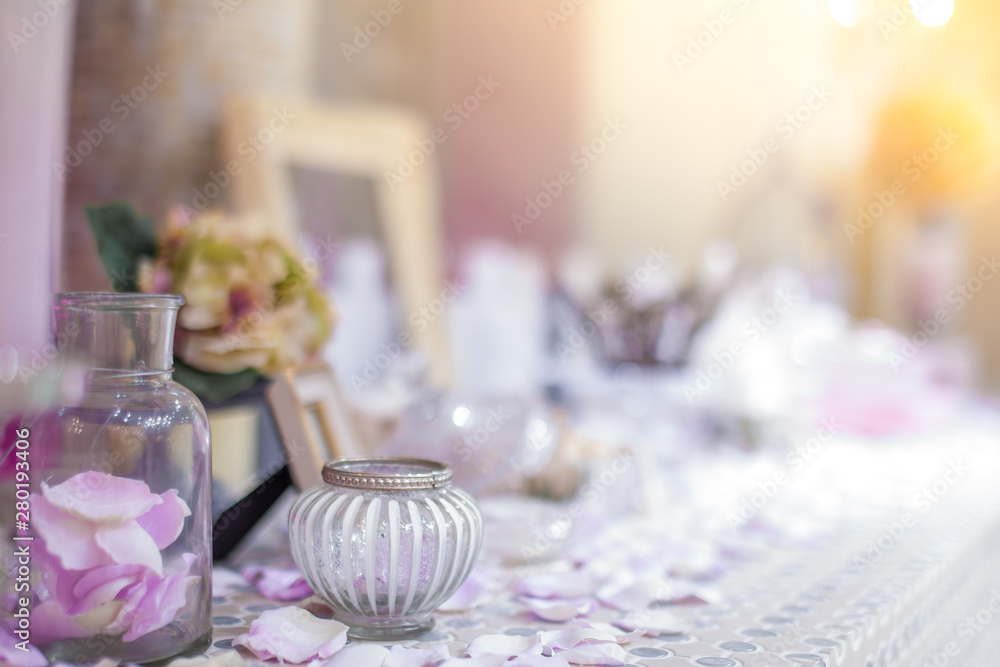 Beautiful vanity with purple flower petals and perfume bottles.dressing on teble for makeup.shallow focus effect. Beautiful vanity with purple flower petals and perfume bottles.dressing on teble for makeup.shallow focus effect.