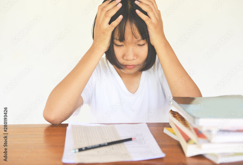 exam stress - education young female college in class taking notes and using a pencil sitting learning concept stressed student girl asian take the exam final with books on the table exam stress - education young female college in class taking notes and using a pencil sitting learning concept stressed student girl asian take the exam final with books on the table