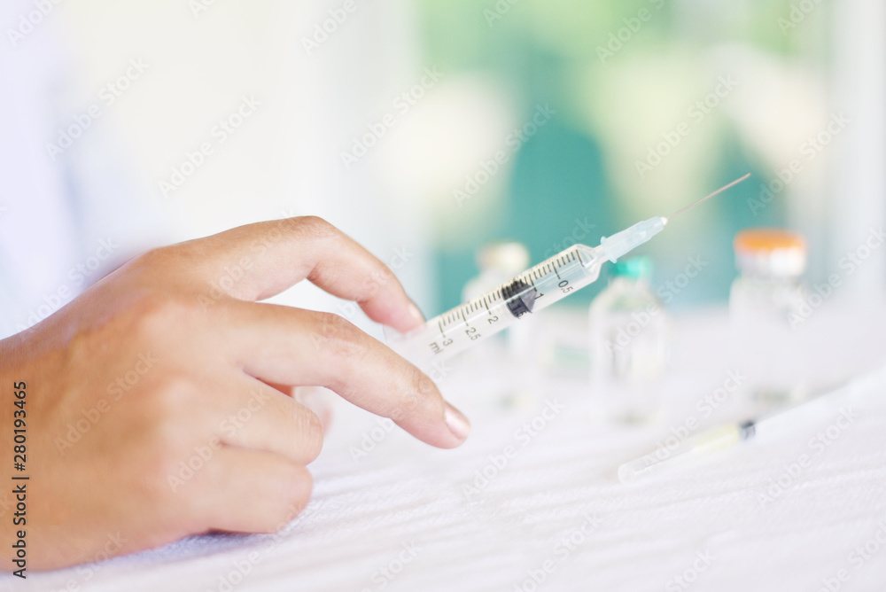 Syringe medication injection and needle in hand nurse asian for giving