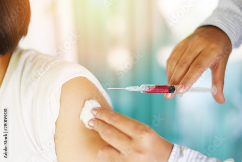 Vaccination of children by injection needle nurses are vaccinations to patients using the syringe in hospital - Doctor giving patient vaccine in arm of asian child girl healthy and medical concept