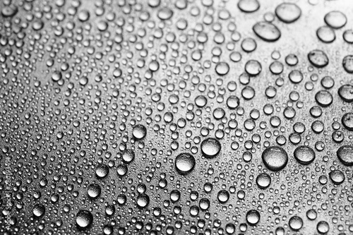 Macro water drops on silvery surface