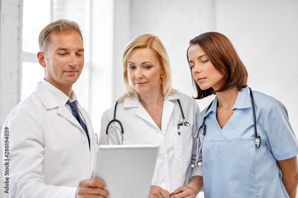 healthcare, medicine and technology concept - group of doctors with tablet computer at hospital healthcare, medicine and technology concept - group of doctors with tablet computer at hospital
