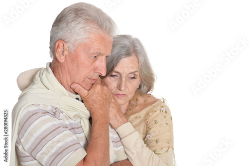 Portrait of sad senior couple posing on white background