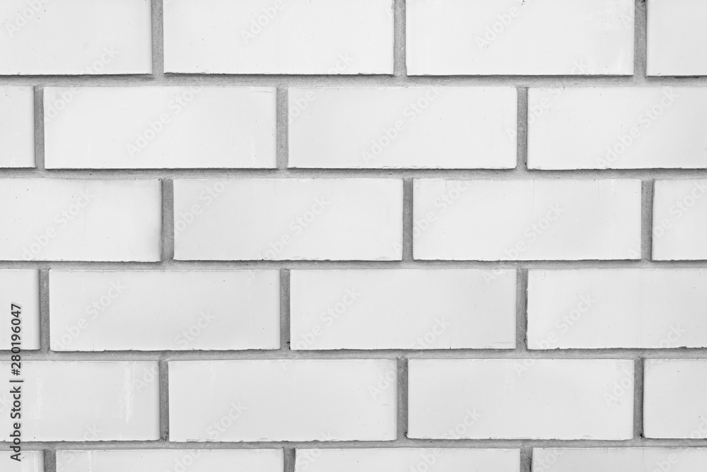 White classic brick wall close-up with stitching. The texture of the stone masonry. Brick background for a subject shooting a flat lay. Concept of construction and interior design. Copy space White classic brick wall close-up with stitching. The texture of the stone masonry. Brick background for a subject shooting a flat lay. Concept of construction and interior design. Copy space