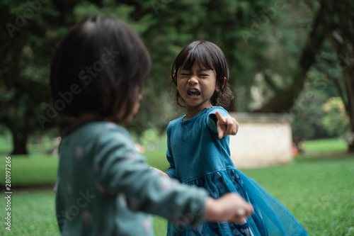 little girls crying sad and angry, two little girls fighting © Odua Images