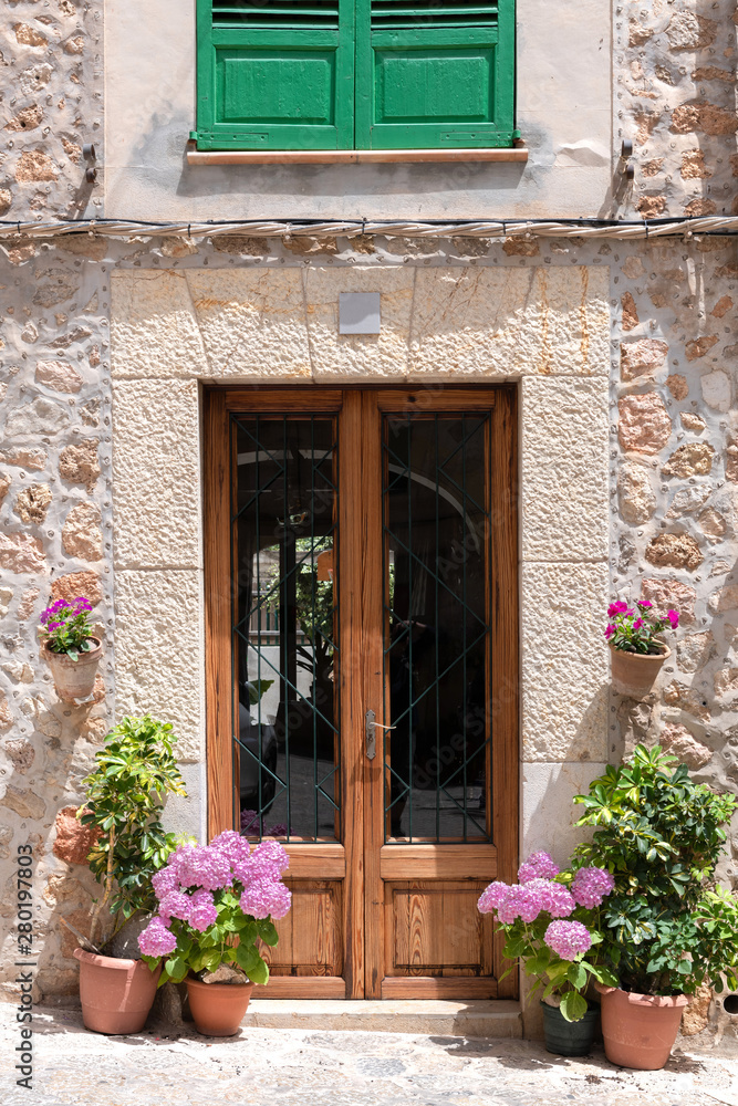 Mallorca - House entrance with hydrangeas and green plants in Valldemossa