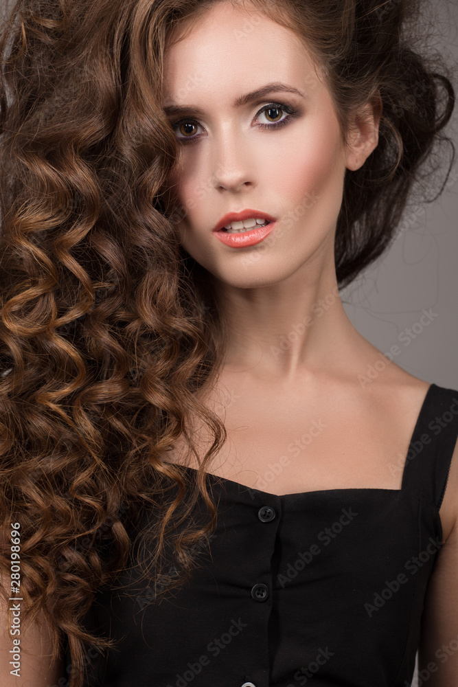 Beautiful woman with curly brown thick hair. Face closeup portrait Beautiful woman with curly brown thick hair. Face closeup portrait