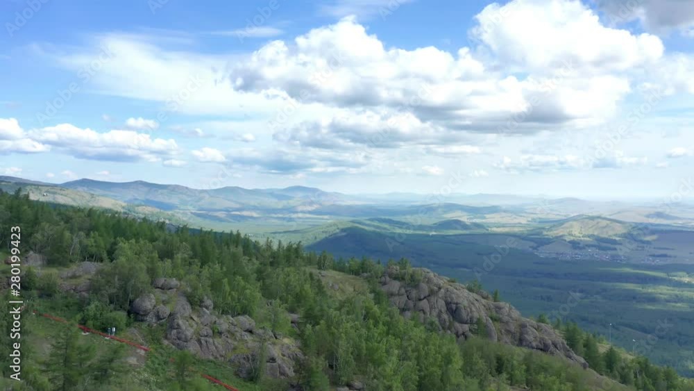 The panorama shot the area. Beautiful view of the mountainous forest terrain. Over the valley are beautiful cumulus clouds. The panorama shot the area. Beautiful view of the mountainous forest terrain. Over the valley are beautiful cumulus clouds.