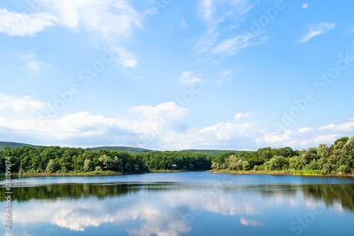 Fototapeta Naklejka Na Ścianę i Meble -  karst lake in green hills in calm summer evening