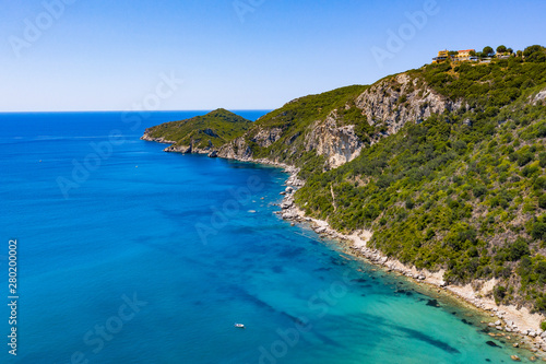 Aerial view of beautiful green and rocky island in the blue ocean. © magdal3na