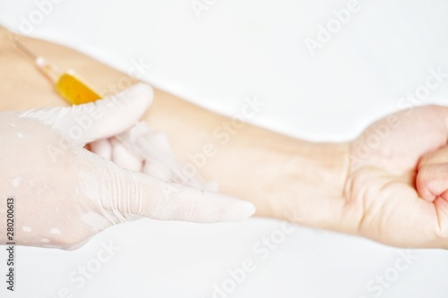 Close up doctor holding medical injection on white background