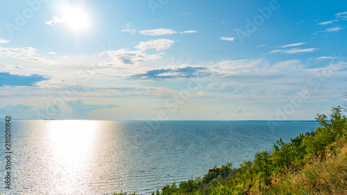 landscape of hills and sea with blue sky