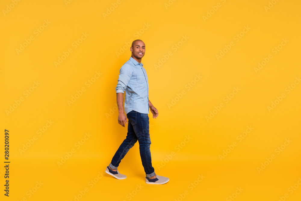 Full length photo of pretty man have promenade move free time isolated over yellow background Full length photo of pretty man have promenade move free time isolated over yellow background