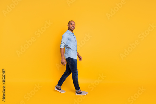 Full length photo of pretty man have promenade move free time isolated over yellow background