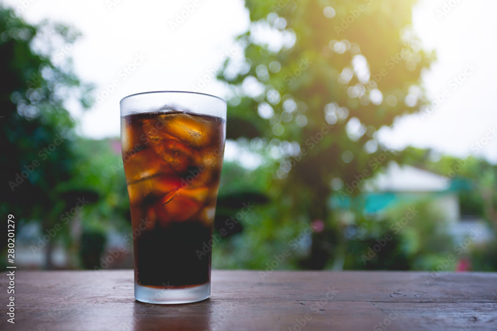 glass of cola with ice on table. glass of cola with ice on table.