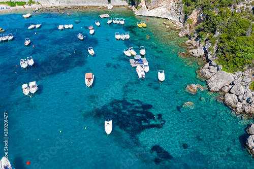 Aerial view of coastline and boats in the sea. Turquoise ocean seen from above.
