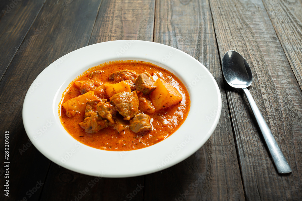 Goulash soup on wooden background. Goulash soup on wooden background.