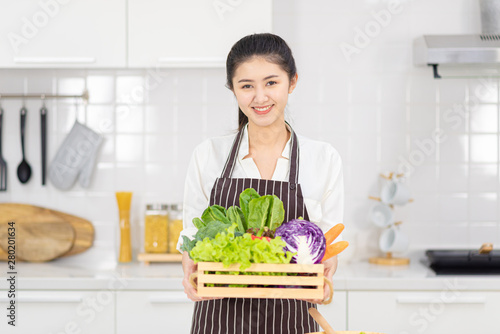 Young Woman Cooking in the kitchen. Healthy Food - Vegetable Salad. Diet. Dieting Concept. Healthy Lifestyle. Cooking At Home. 