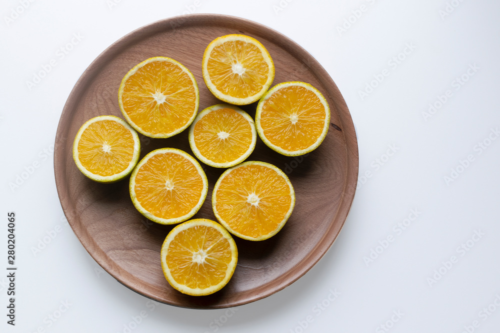 oranges in halves in a wood plate oranges in halves in a wood plate
