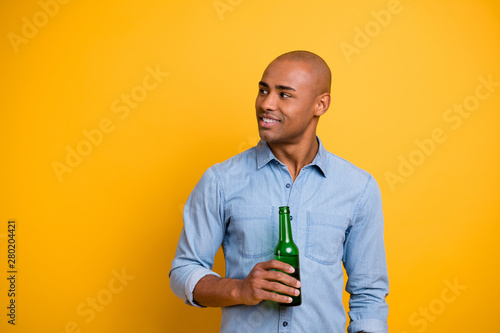 Photo of dark skin macho raise hold hand beer bottle listen friends sport bar wear jeans denim shirt isolated bright yellow background