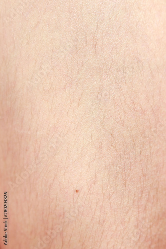 hairy legs before epilation with long black hair. Macro.