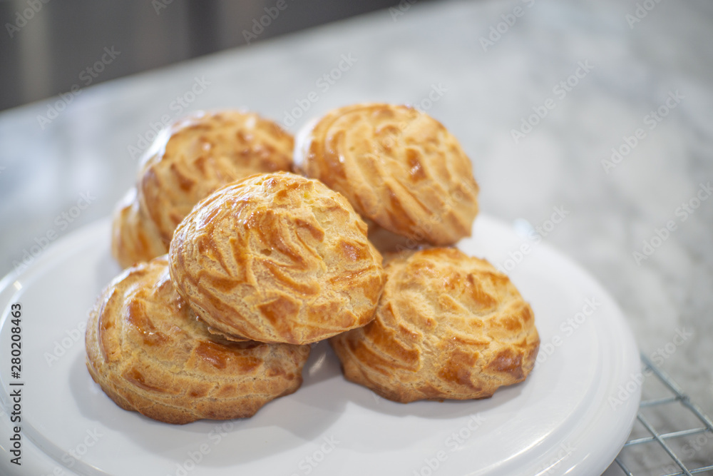 Side view of Choux Cream on a rack.