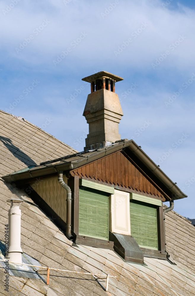 Mansard roof and chimney pot of a cottage