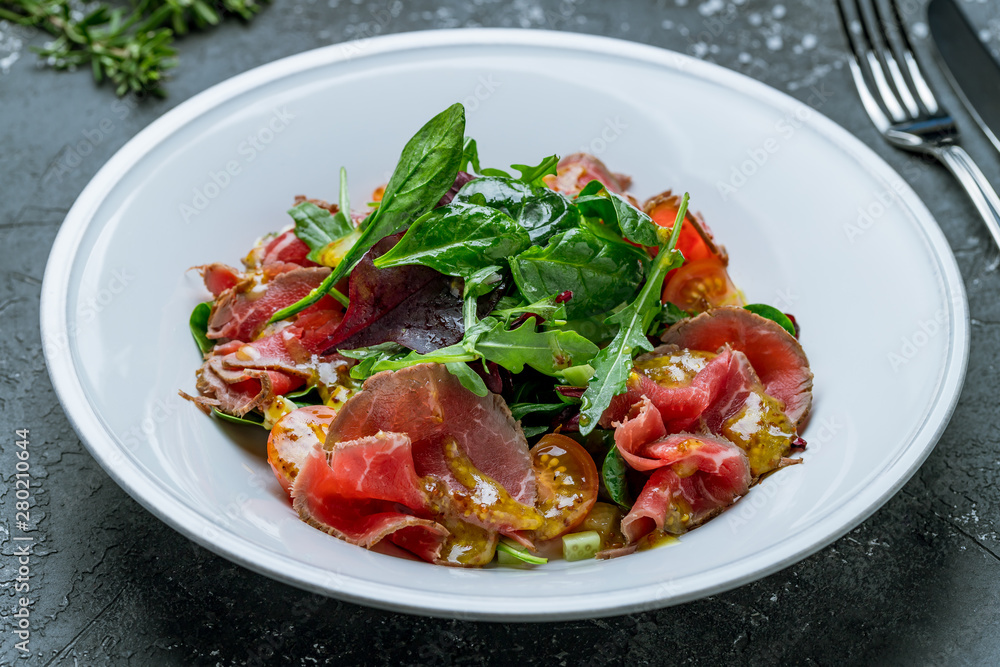 Salad with roast beef on white plate Salad with roast beef on white plate