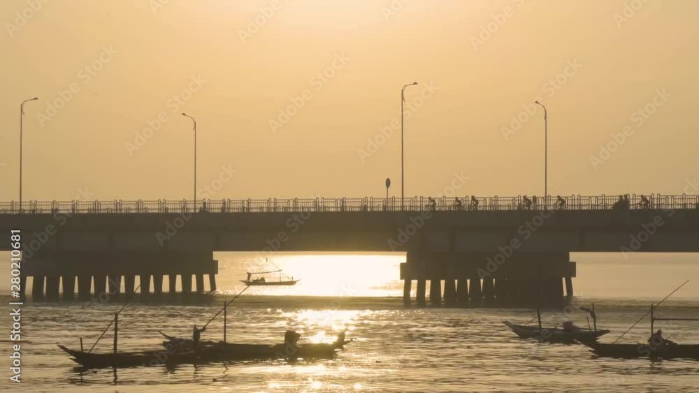 Beautiful view of Suramadu bridge with fisherman boats and sunlight reflection on misty morning in Surabaya city to Madura island at East Java, Indonesia. Shot in 4k resolution Beautiful view of Suramadu bridge with fisherman boats and sunlight reflection on misty morning in Surabaya city to Madura island at East Java, Indonesia. Shot in 4k resolution