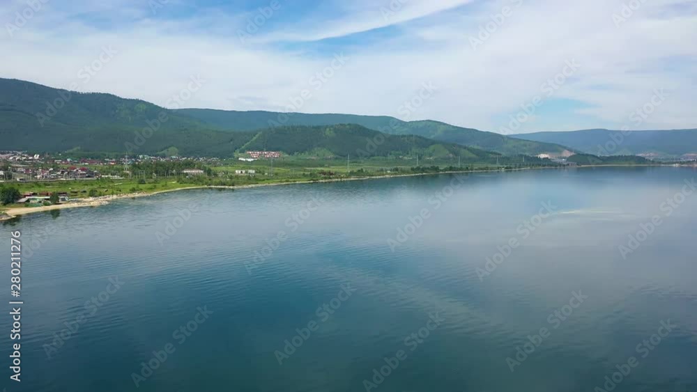 Overview of the beautiful summer landscape. UAV flight over the river and the village. Bird's-eye view Overview of the beautiful summer landscape. UAV flight over the river and the village. Bird's-eye view