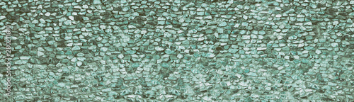 Teal natural stone wall wide texture. Rough rock panoramic retro background. Long vintage backdrop