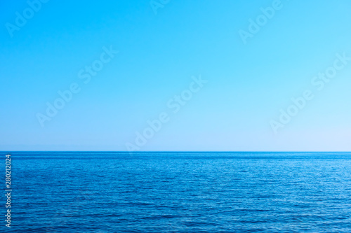 Seascape with sea horizon and clear blue sky