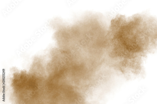 Brown color powder explosion cloud on white background.Brown dust splashing on background.