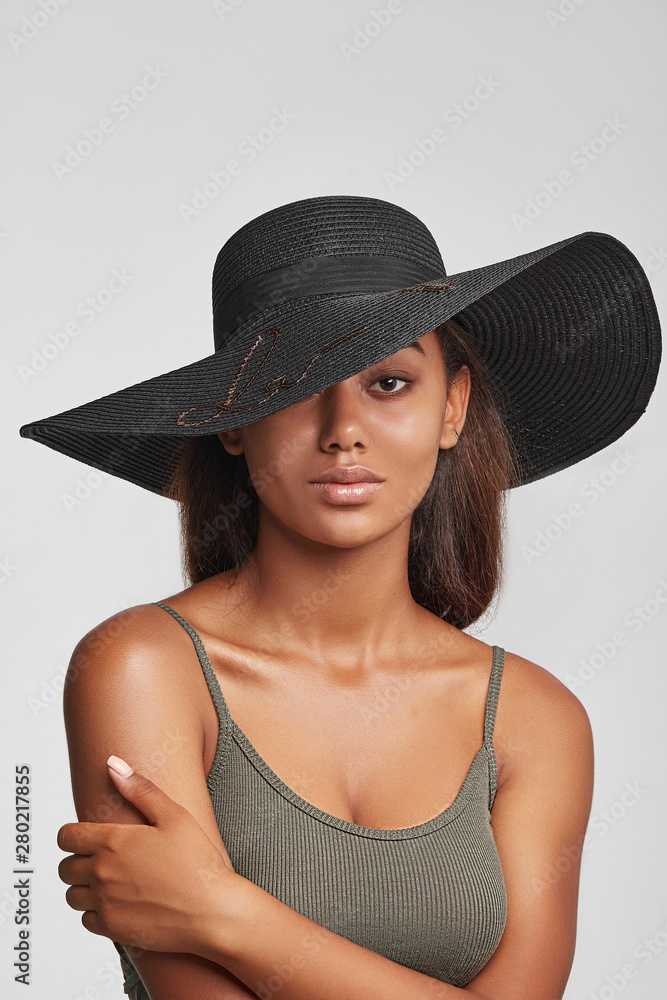 young girl, dark-skinned girl, smiling girl, brunette girl, hat with a wide  brim, black hat,