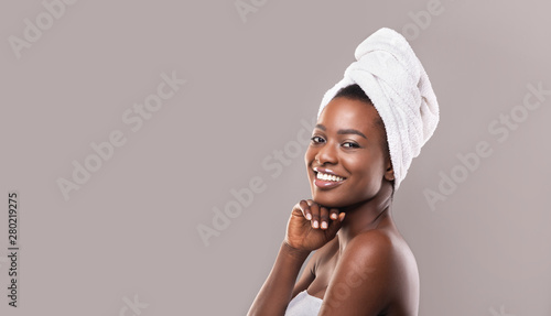 Beautiful african american woman after bath with towel on head