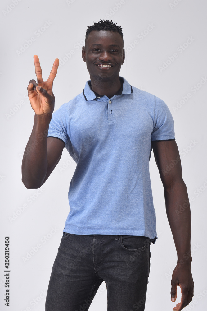 african man making the victory sign on a white background african man making the victory sign on a white background