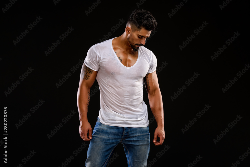 Handsome Male Fitness Model Wearing Jeans and White T-Shirts Stock Photo |  Adobe Stock