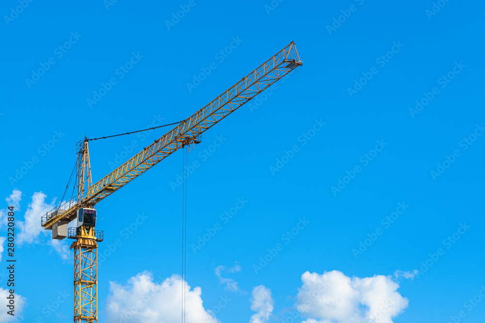 Big yellow crane with blue sky