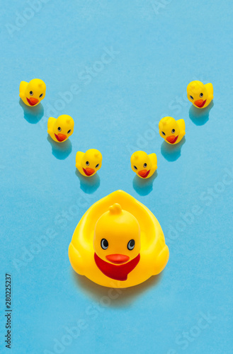 Baby Duck Toys with Mom (Big Duck) on Blue Background, with Copyspace included. Summer Concept.