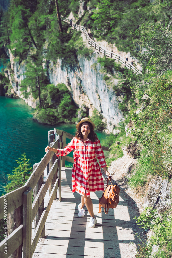 woman walking by hiking trail around braies lake in italy dolomites mountains. activity leisure lifestyle woman walking by hiking trail around braies lake in italy dolomites mountains. activity leisure lifestyle