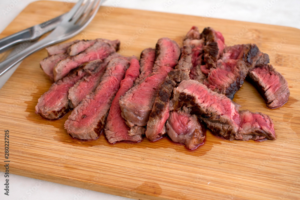Sliced Rare Steak on a Cutting Board