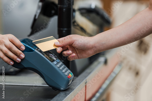 cropped view of man paying by credit card near cashier in supermarket © LIGHTFIELD STUDIOS