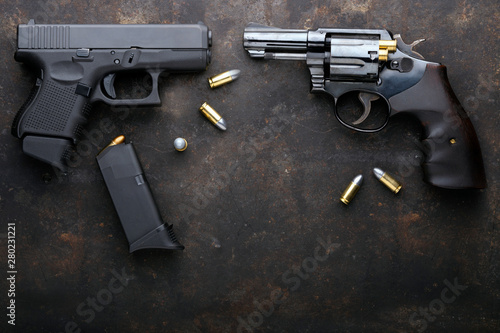 Gun with ammunition on iron dark background. photo