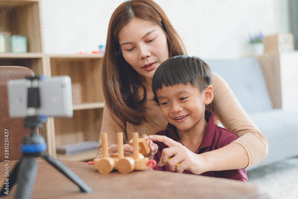 Mother and baby playing with a smartphone,Lifestyle in harmony with the modern technology.Social media on the lives of people in modern times.