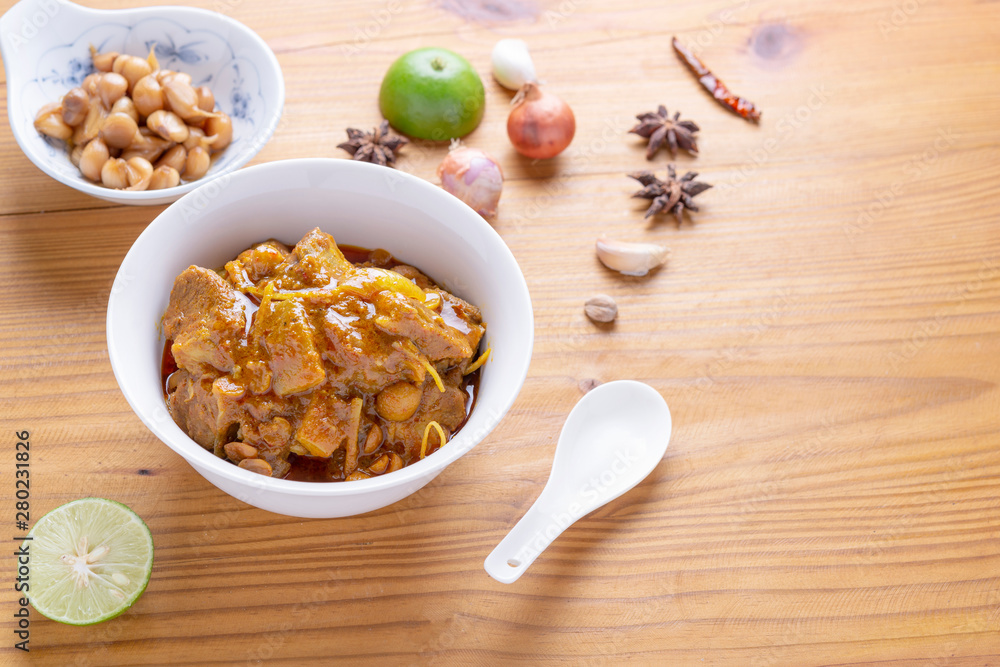 Fototapeta premium Red curry or Pork curry on wood table soft background, thai food, india food, Thai Food name Hung Ley