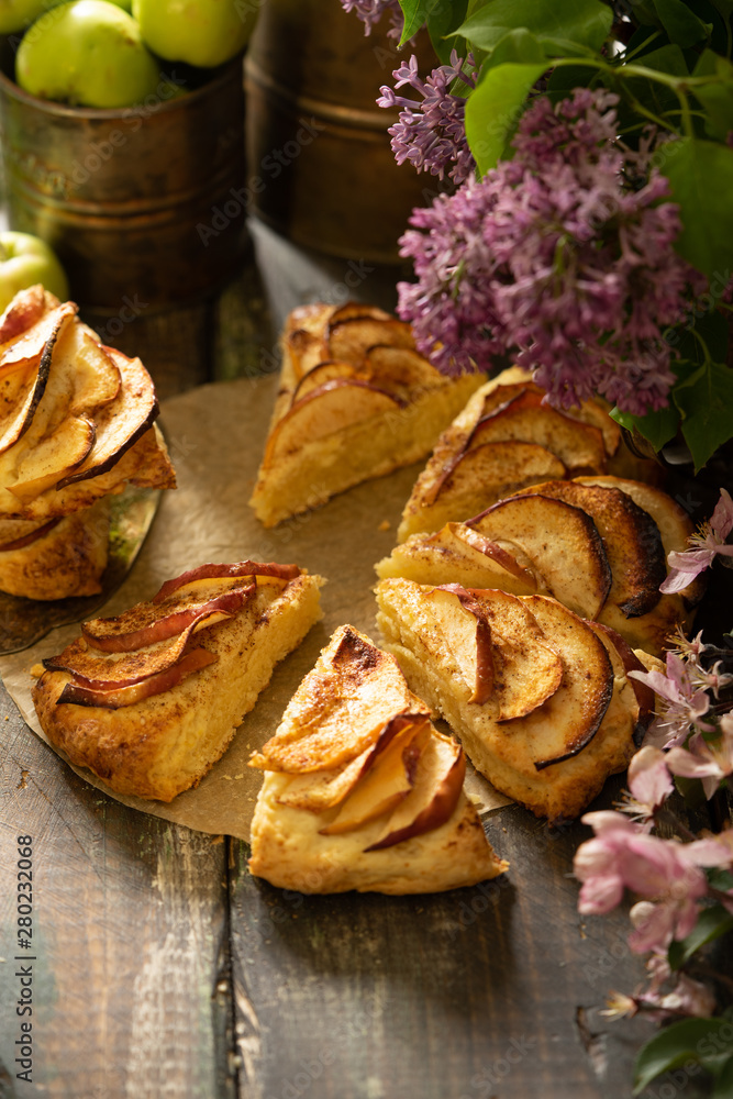 homemade apple cinnamon scones with lilac flowers and apple blooming branches. English breakfast or brunch at the village homemade apple cinnamon scones with lilac flowers and apple blooming branches. English breakfast or brunch at the village